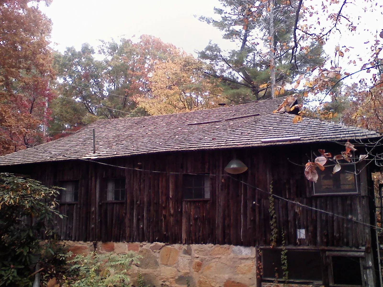 Weathered wood shake roof on a rustic board sided cabin in New Troy